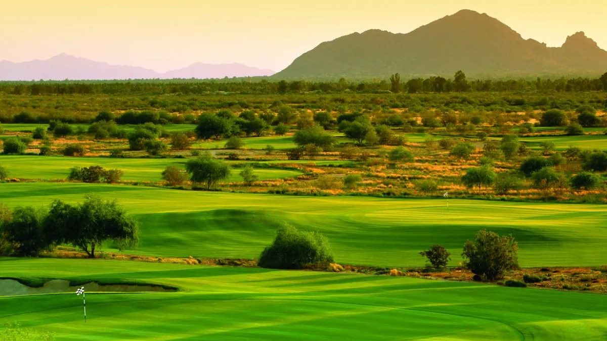 Talking Stick North fairways at sunset with mountains behind